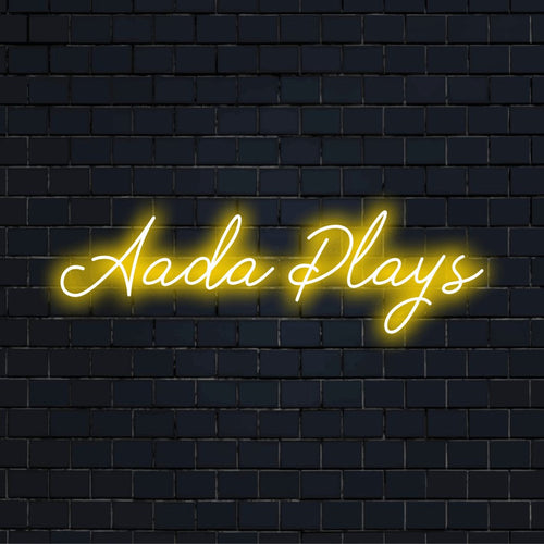 Aada Plays Personalized Neon Light with glowing wall decor on dark brick wall