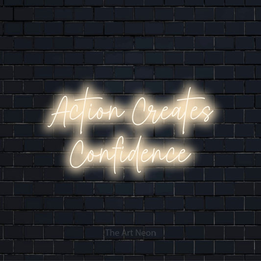 "Action Creates Confidence" LED neon sign on a black brick wall