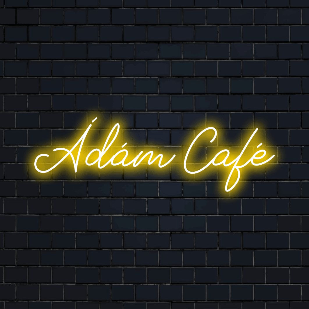 Adam Cafe Personalized Neon Light with bright neon lettering against brick backdrop