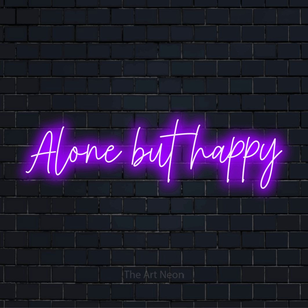 "Alone But Happy" LED neon sign on a black brick wall