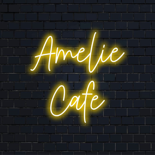 Amelie Cafe Personalized Neon Light with soft neon glow against black brick wall
