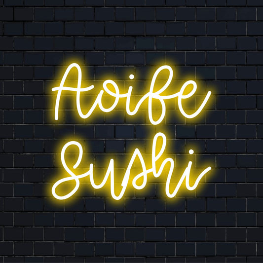 Aoife Sushi Personalized Neon Light with glowing lettering on black brick background