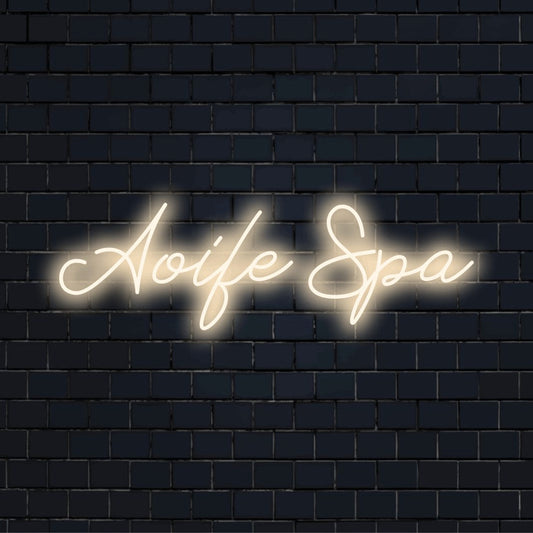 Aoife Spa Personalized LED Neon Sign, bright LED glow on dark brick background