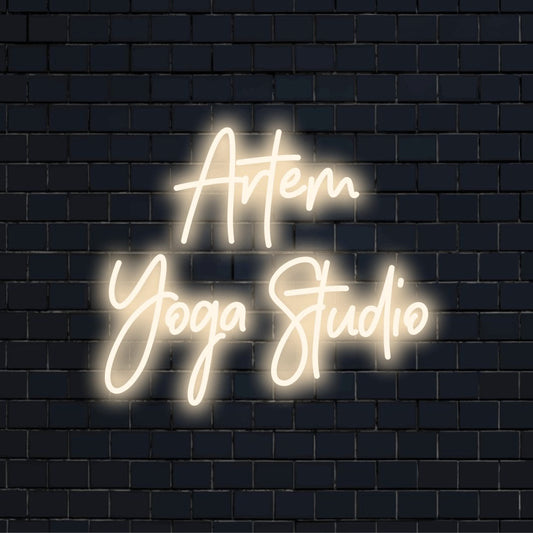 Artem Yoga Studio Personalized LED Neon Sign, bright neon glow against brick backdrop