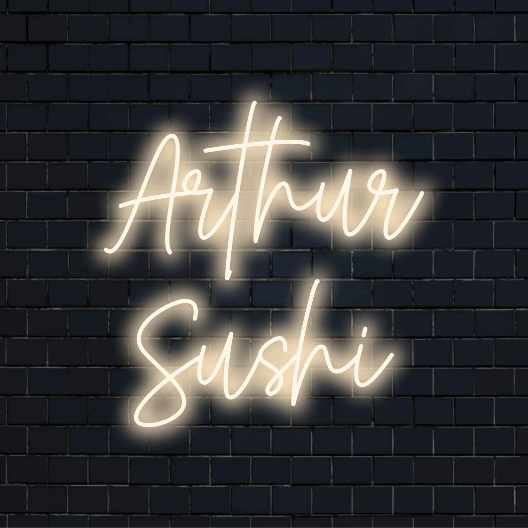 Arthur Sushi Personalized LED Neon Sign, bright neon glow against brick backdrop