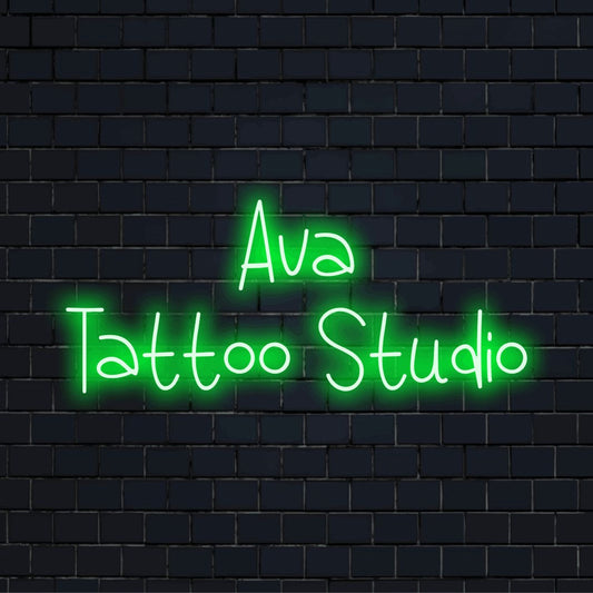Ava Tattoo Studio Custom Name Neon Sign, bright neon glow against black brick wall
