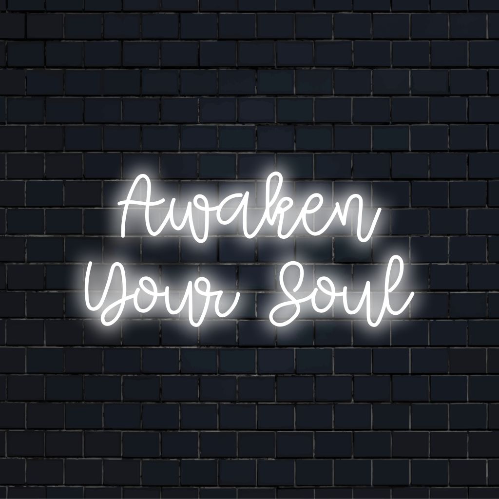 Awaken Your Soul Neon Light with bright neon glow against black brick wall