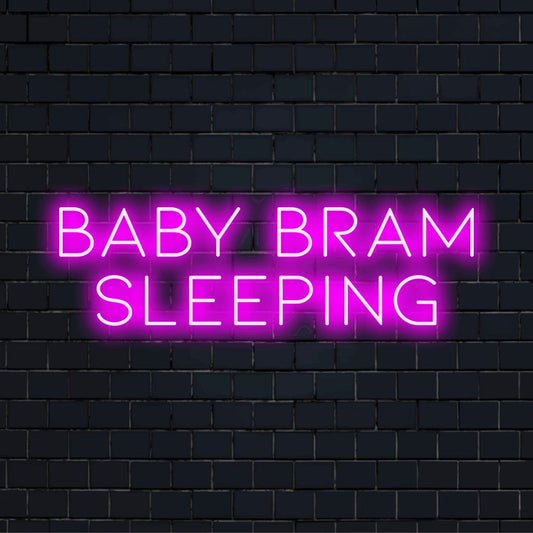 Baby Bram Sleeping Personalized LED Neon Sign, soft neon glow against black brick wall