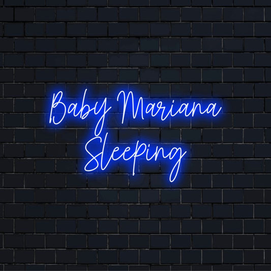 Baby Mariana Sleeping Custom Name Neon Sign, bright neon glow against black brick wall