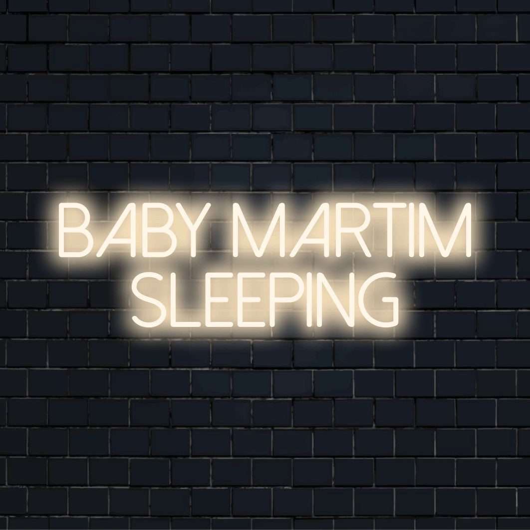 Baby Martim Sleeping Custom Name Neon Sign, glowing neon text on dark brick wall