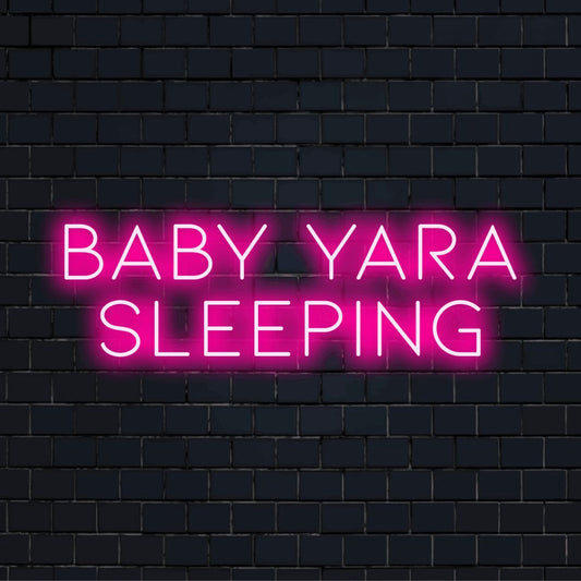 Baby Yara Sleeping Custom Name Neon Sign, bright neon glow on dark brick wall