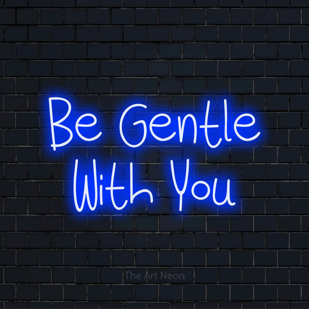 "Be Gentle With You" script-style LED neon sign on a black brick wall