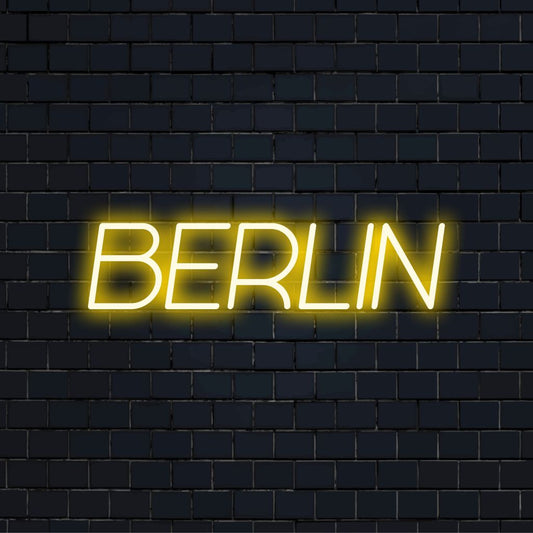 Berlin Neon Sign, glowing lettering against black brick wall