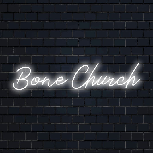 Bone Church Neon Light with bright neon glow on dark brick background