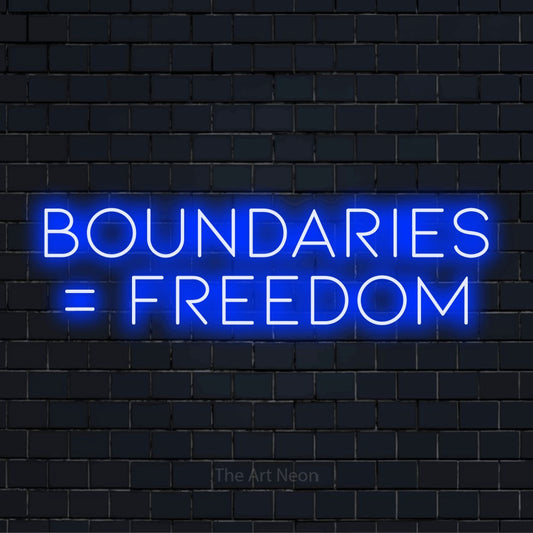 "Boundaries = Freedom" LED neon sign on a black brick wall