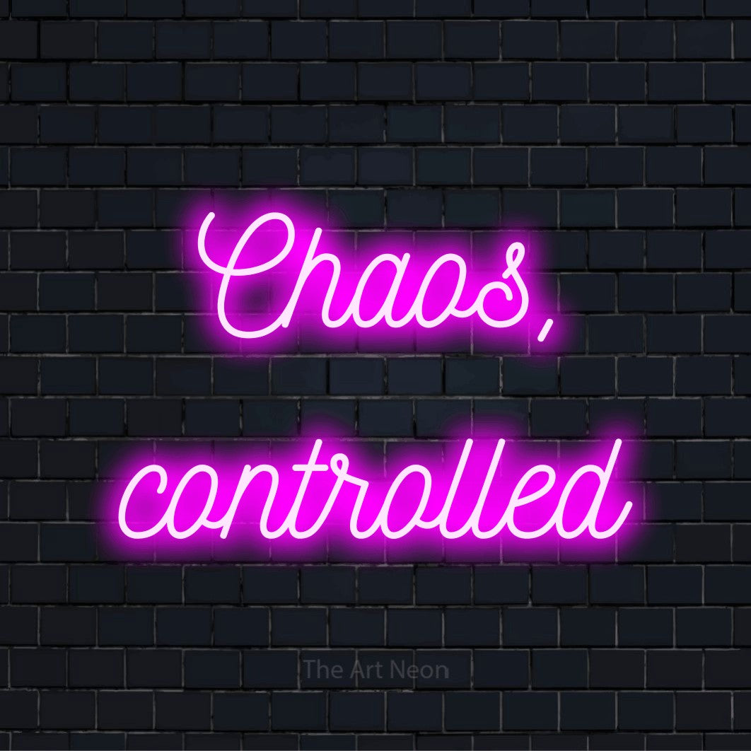 "Chaos, Controlled" script-style LED neon sign on a black brick wall