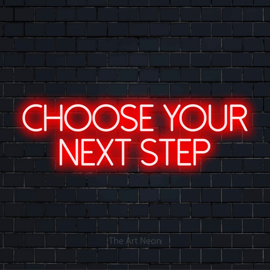 "Choose Your Next Step" script-style LED neon sign on a black brick wall