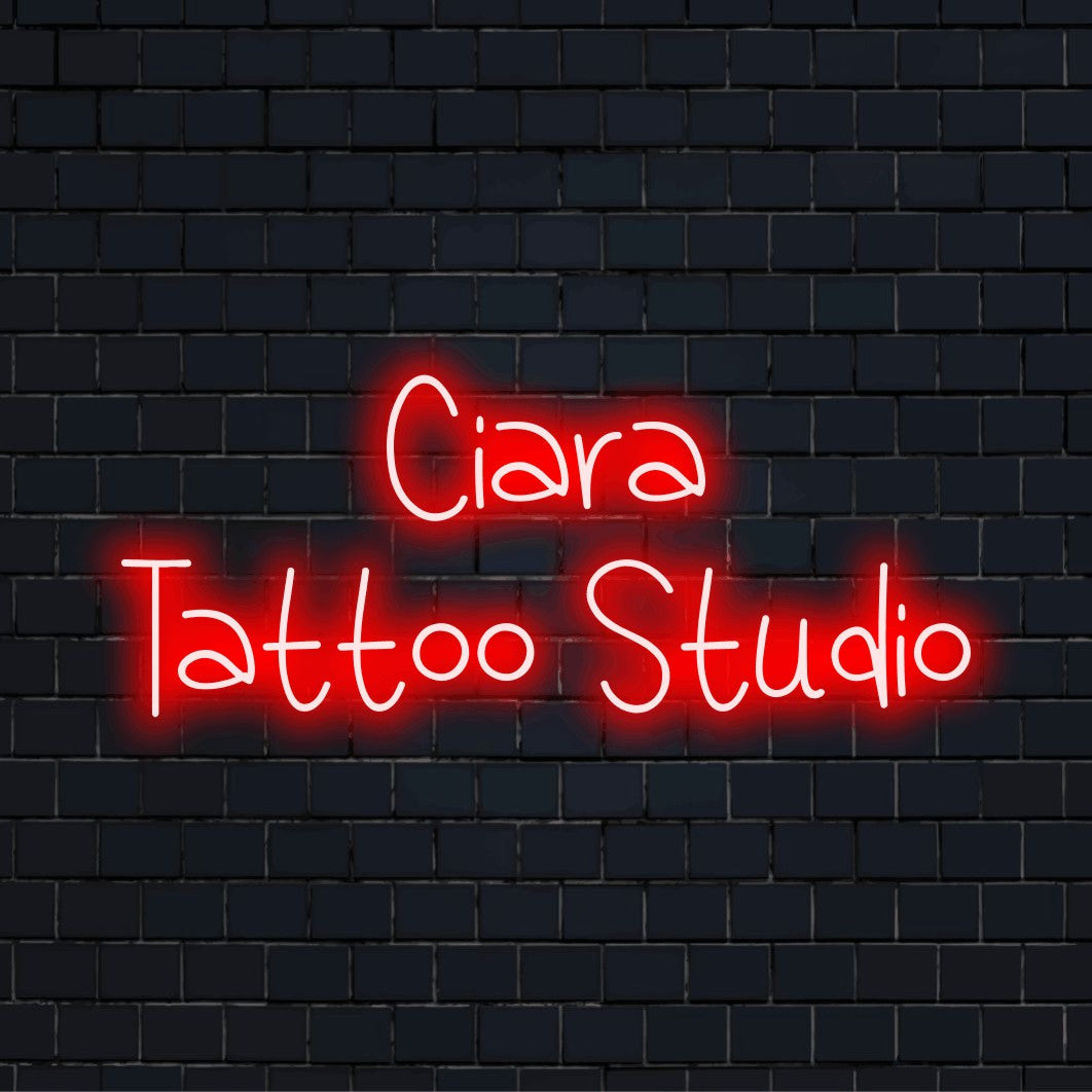 Ciara Tattoo Studio Personalized LED Neon Sign, glowing neon text on dark brick background