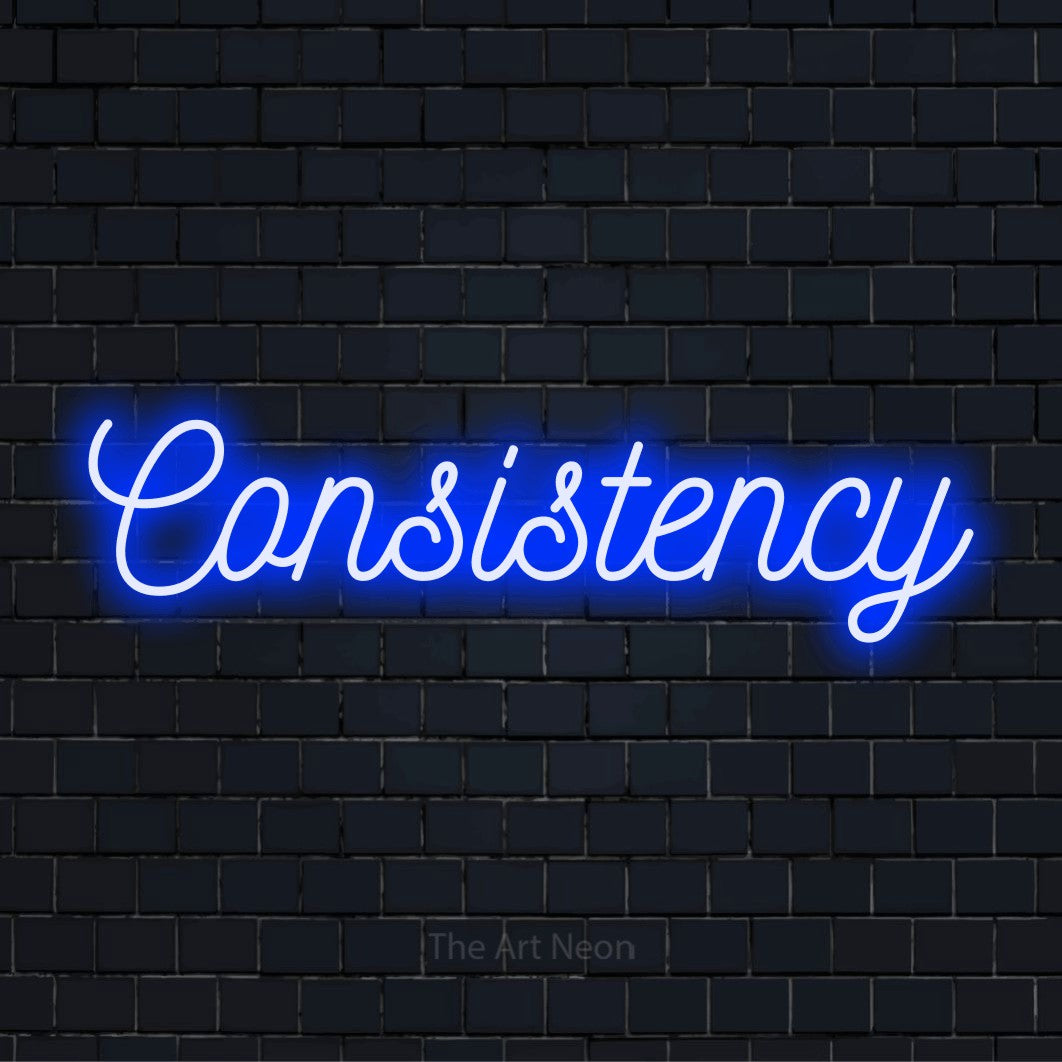 "Consistency" glowing LED neon sign on a black brick wall