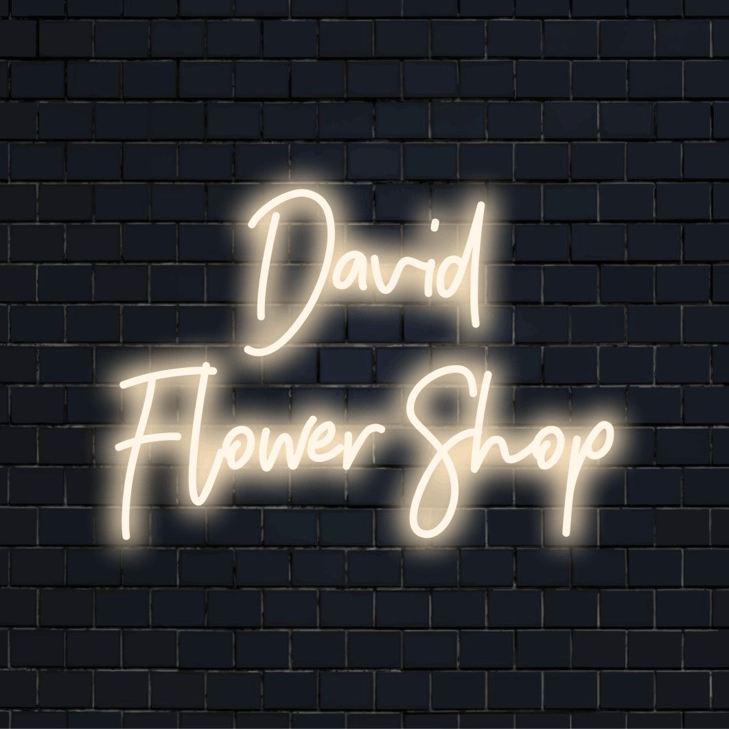David Flower Shop Custom Name Neon Sign, glowing neon text against brick backdrop