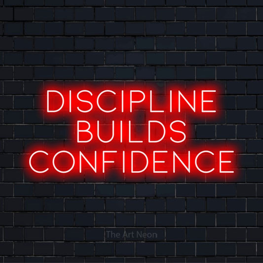 "Discipline Builds Confidence" glowing LED neon sign on a black brick wall