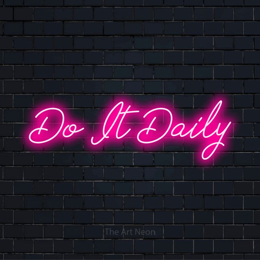 "Do It Daily" script-style LED neon sign on a black brick wall