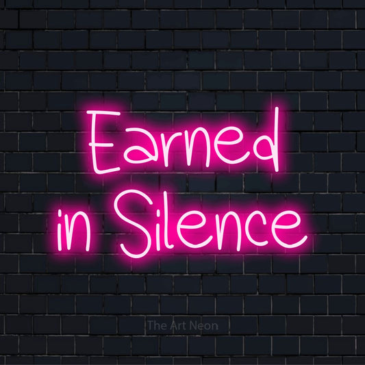 "Earned In Silence" text design with neon effect on a black brick wall