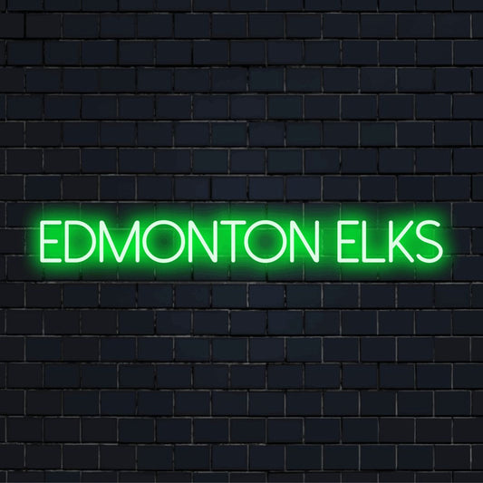 Edmonton Elks Neon Light with bright neon lettering on dark brick wall
