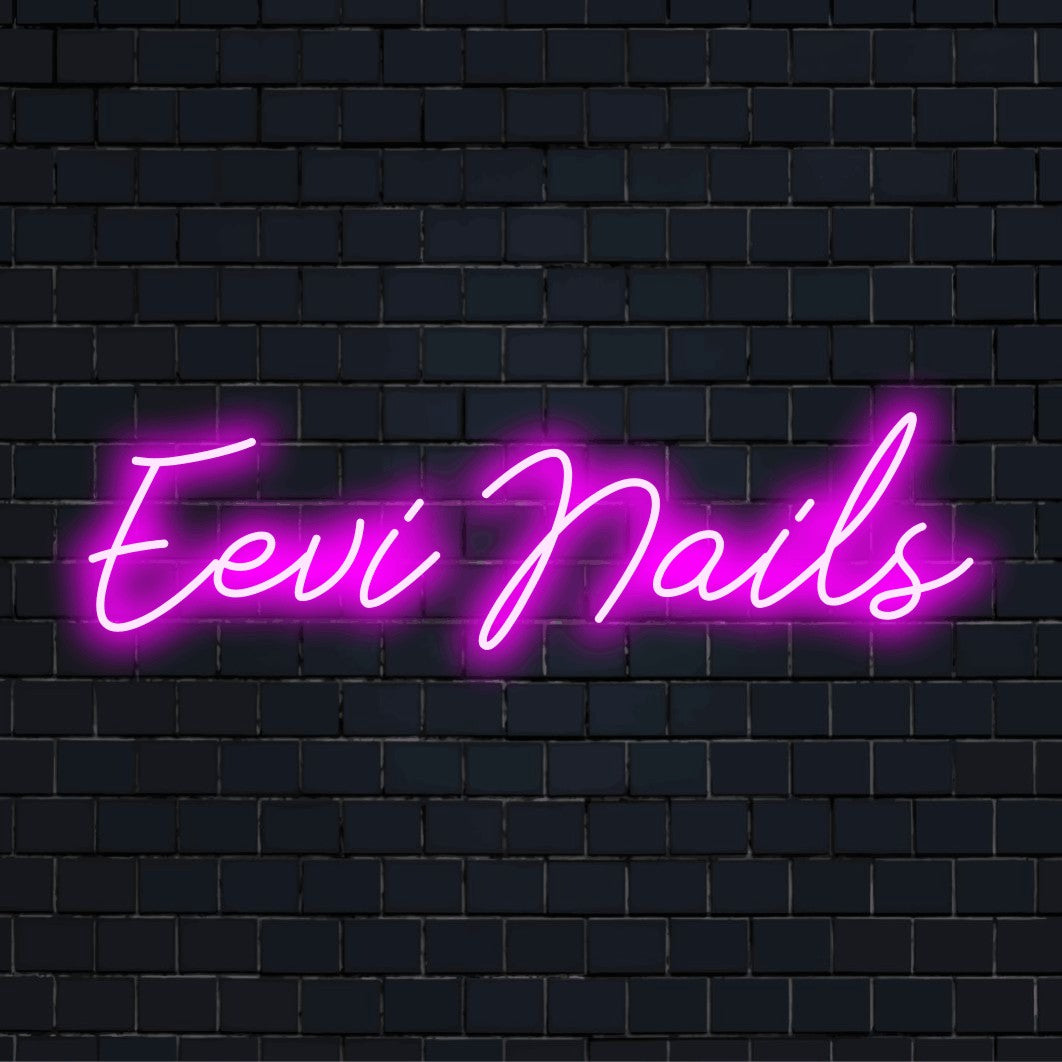 Eevi Nails Custom Name Neon Sign, bright neon glow against brick backdrop