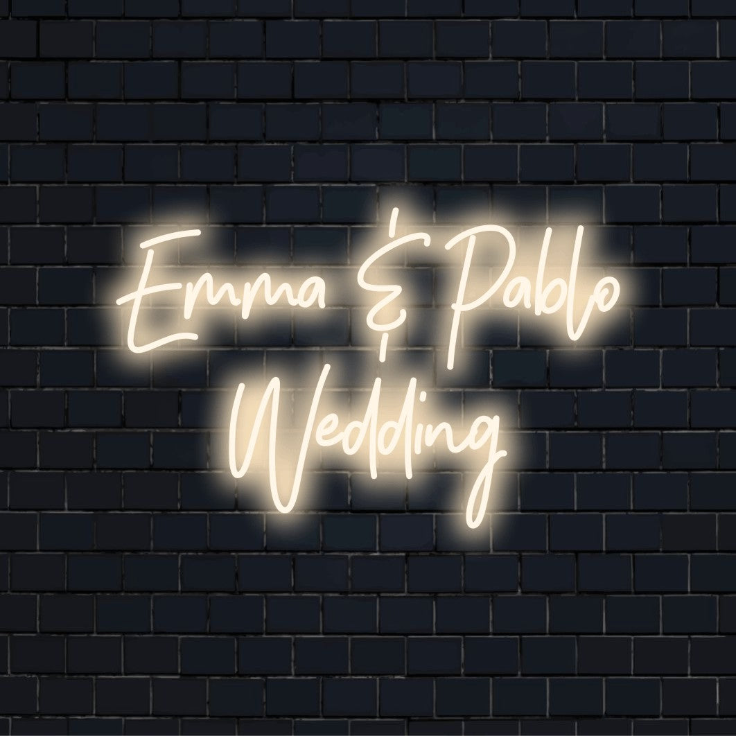 Emma _ Pablo Wedding Personalized Neon Light with glowing wall decor against black brick wall