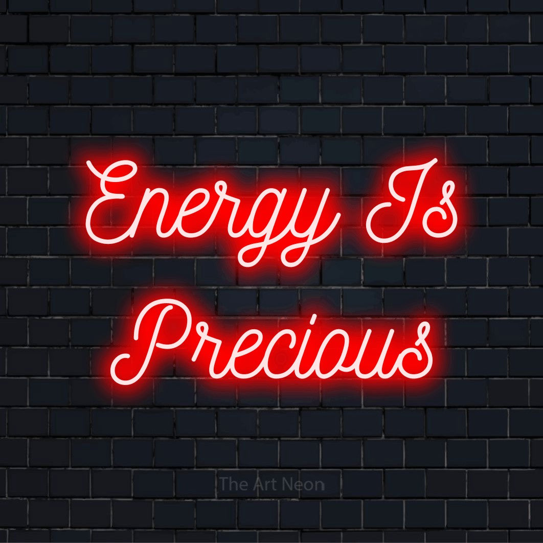 "Energy Is Precious" LED neon sign on a black brick wall