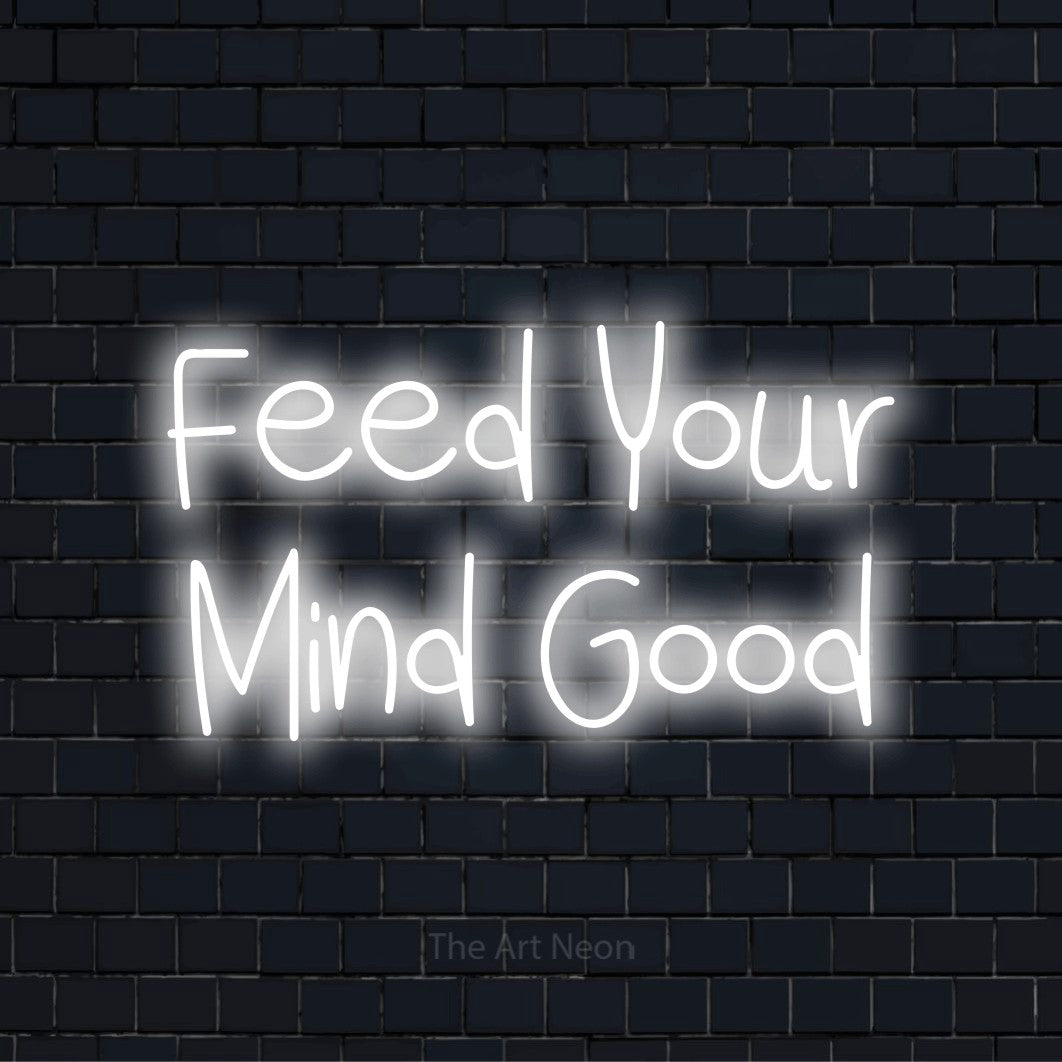 "Feed Your Mind Good" script-style LED neon sign on a black brick wall