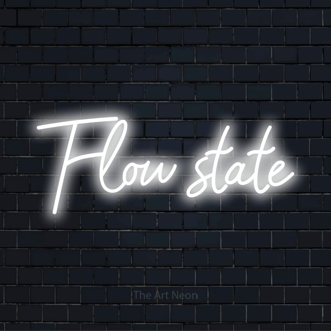 "Flow State" glowing LED neon sign on a black brick wall