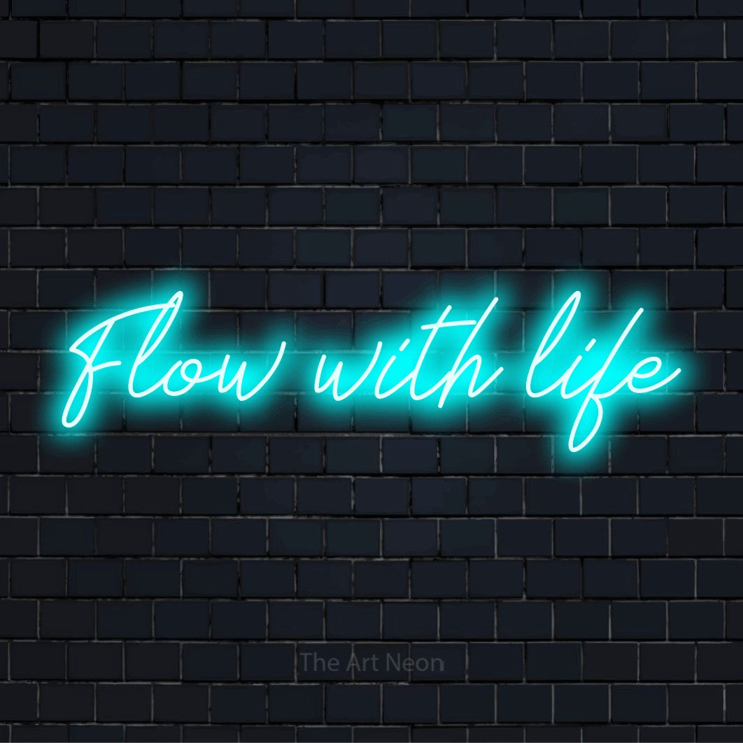 "Flow With Life" LED neon sign on a black brick wall