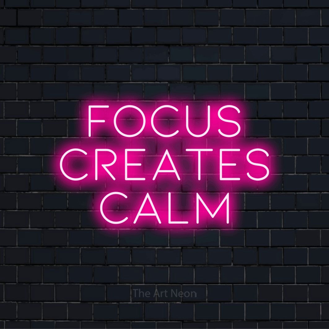 "Focus Creates Calm" text design with neon effect on a black brick wall
