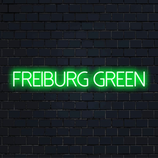 Freiburg Green Neon Sign, glowing wall decor against brick backdrop