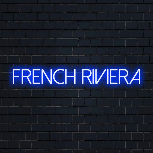 French Riviera LED Neon Sign, glowing neon text on black brick background