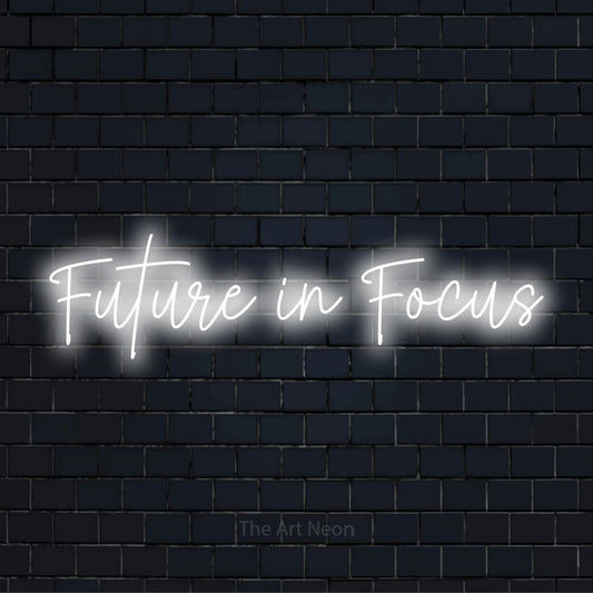 "Future In Focus" LED neon sign on a black brick wall
