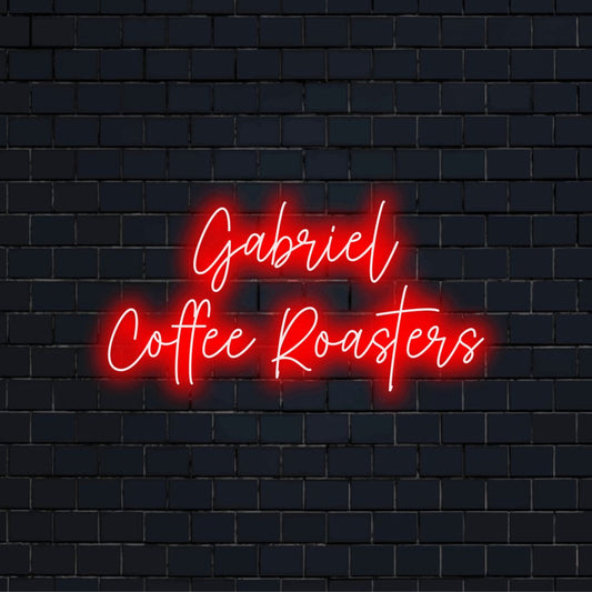 Gabriel Coffee Roasters Personalized Neon Light with bright neon glow on dark brick wall