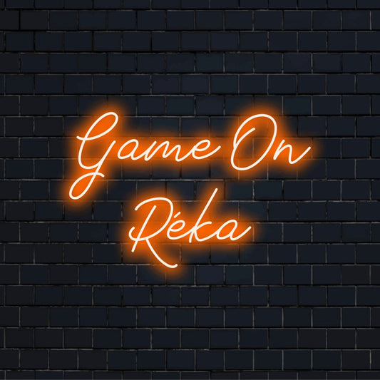 Game On Reka Personalized Neon Light with bright neon lettering against black brick wall