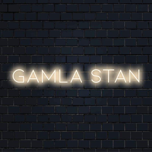 Gamla Stan Neon Sign, bright neon lettering on black brick background