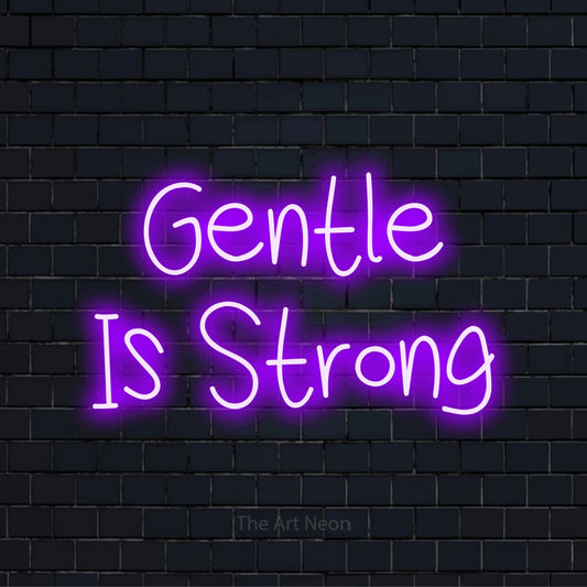 "Gentle Is Strong" text design with neon effect on a black brick wall