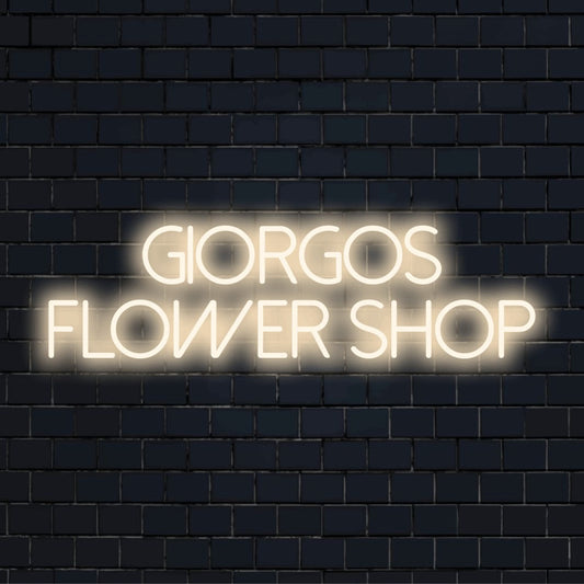 Giorgos Flower Shop Custom Name Neon Sign, neon text light on dark brick wall