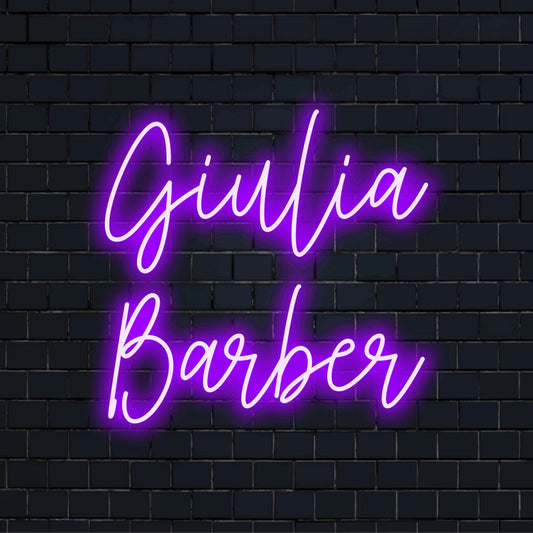 Giulia Barber Custom Name Neon Sign, bright LED glow against black brick wall