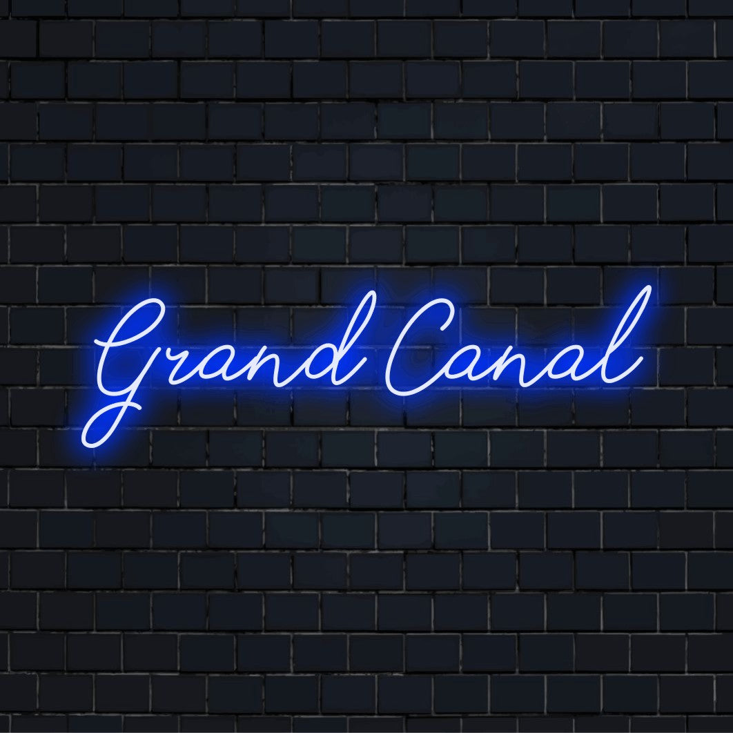Grand Canal Neon Sign, glowing wall decor against brick backdrop