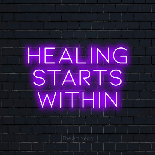 "Healing Starts Within" text design with neon effect on a black brick wall