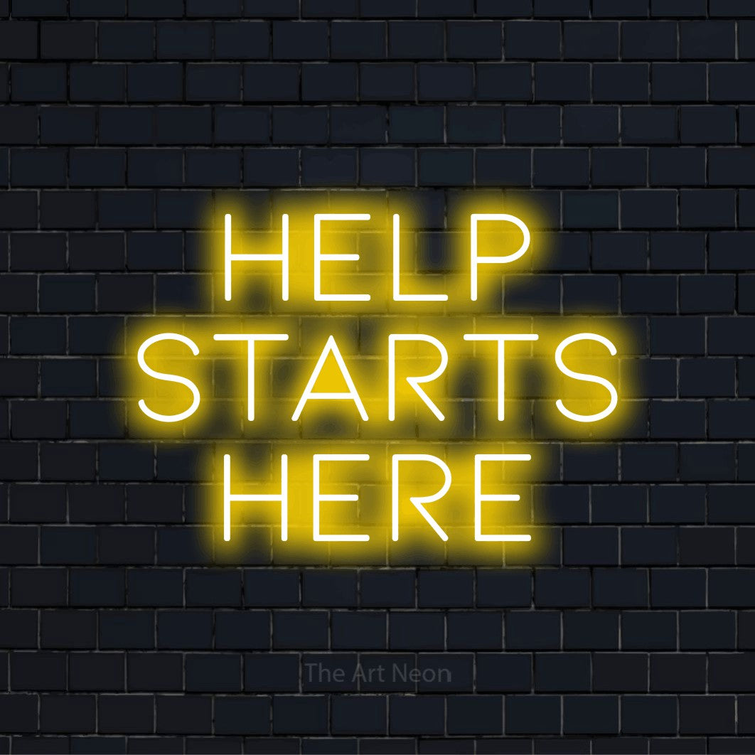 "Help Starts Here" LED neon sign on a black brick wall