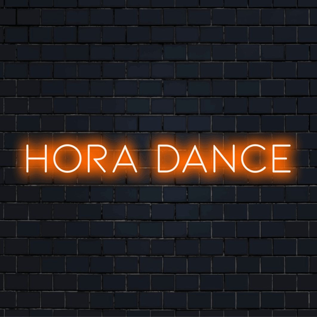 Hora Dance LED Neon Sign, glowing wall decor against black brick wall