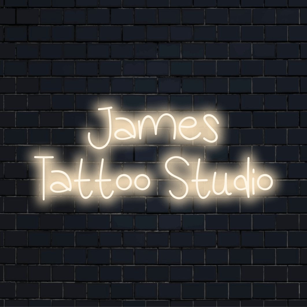 James Tattoo Studio Personalized LED Neon Sign, glowing wall decor on dark brick background