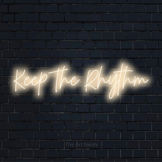 "Keep The Rhythm" glowing LED neon sign on a black brick wall